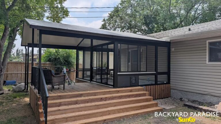 Black gable sunroom with extended roofline on deck installed in Stonewall, Manitoba.