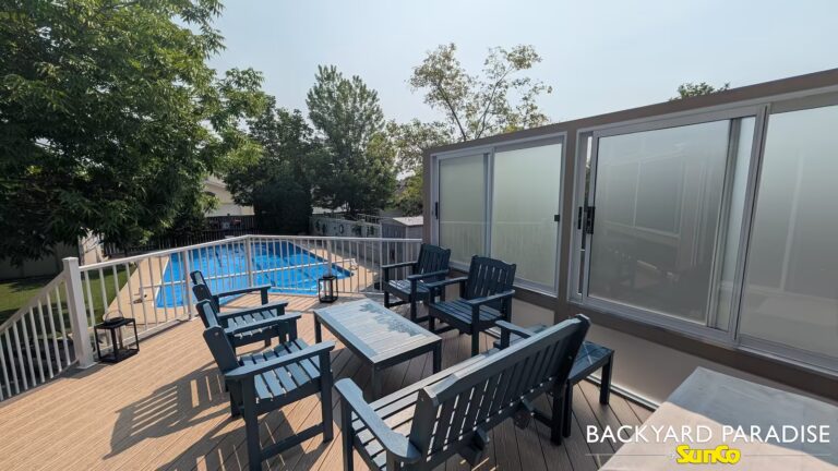 Composite deck with privacy wall and white aluminum picket rail in South St Vital, Winnipeg