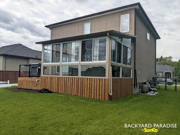 Sandalwood and white studio sunroom with black aluminum railings in Stonewall, Manitoba