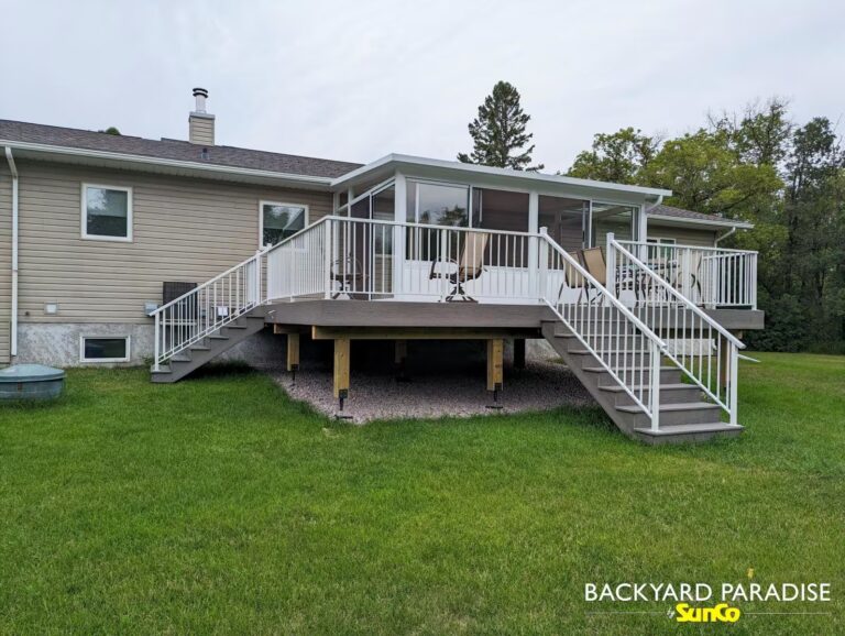 White studio sunroom with composite deck and white aluminum railing in Balmoral, Manitoba